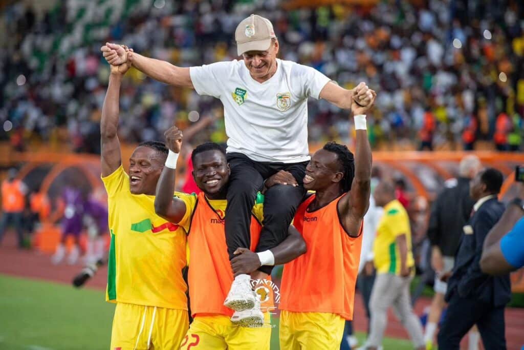Benin players celebrate with Gernot Rohr