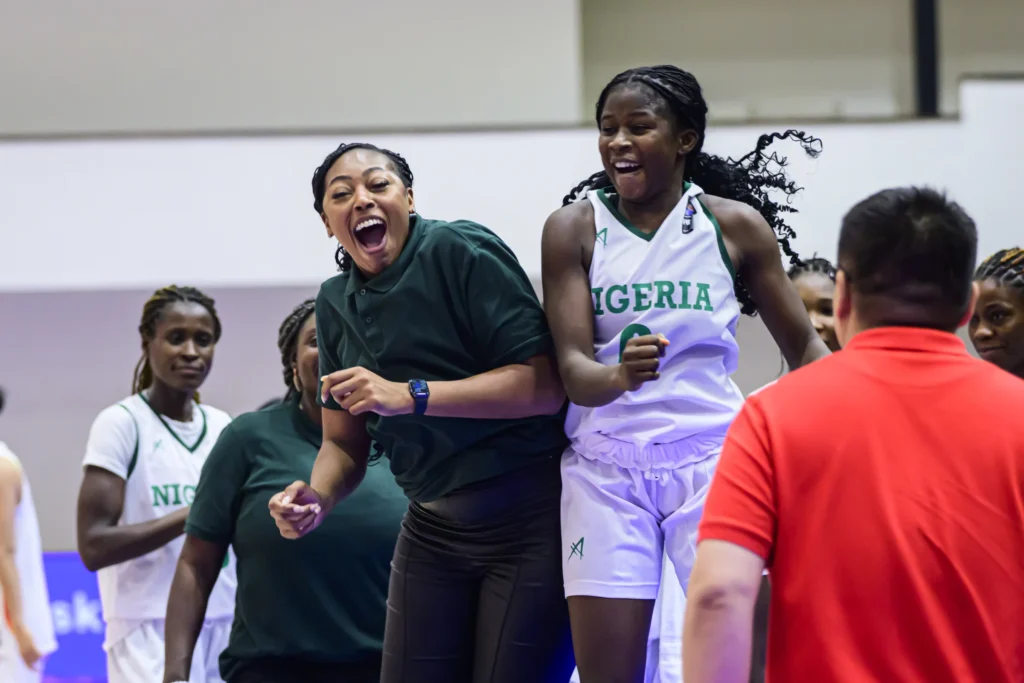 Junior D'Tigress assistant coach Atonye Nyingifa celebrates with guard Wandoo Marvis Hembam