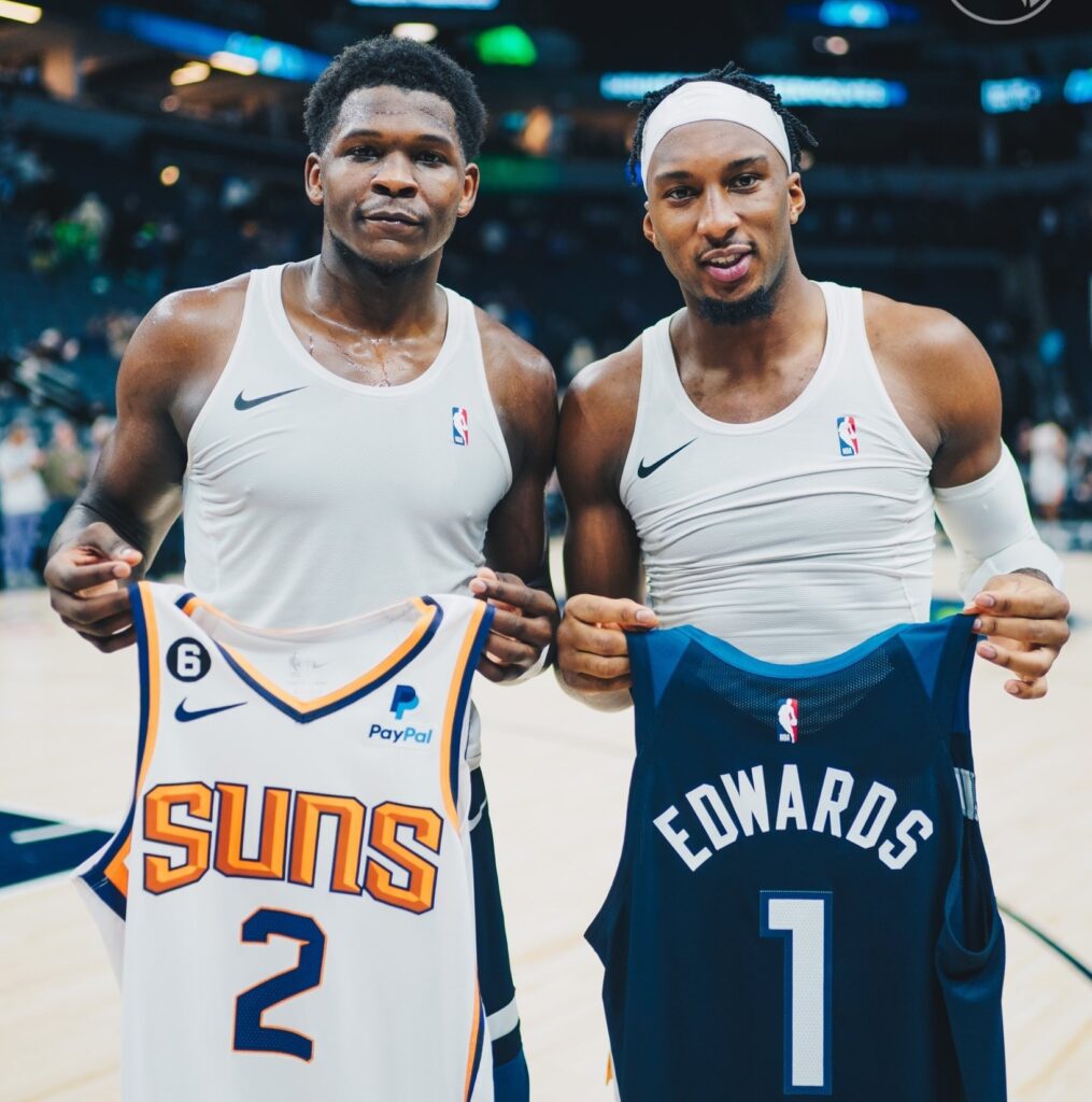 Anthony Edwards (left) and Josh Okogie exchange jerseys 