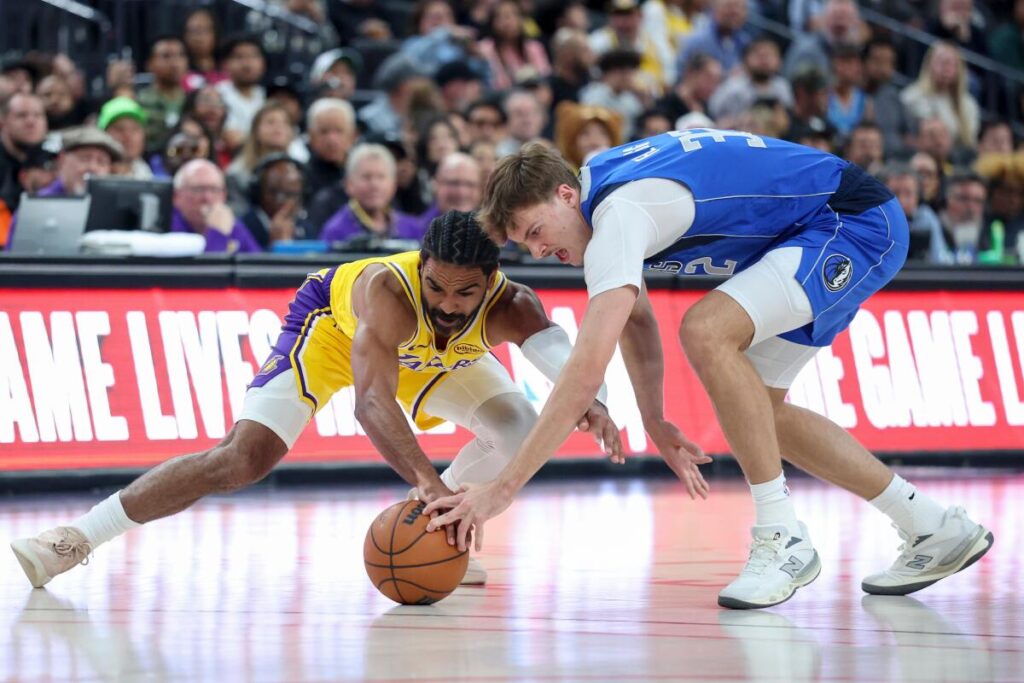 Gabe Vincent (left) vying for the ball with rookie Cooper Flagg