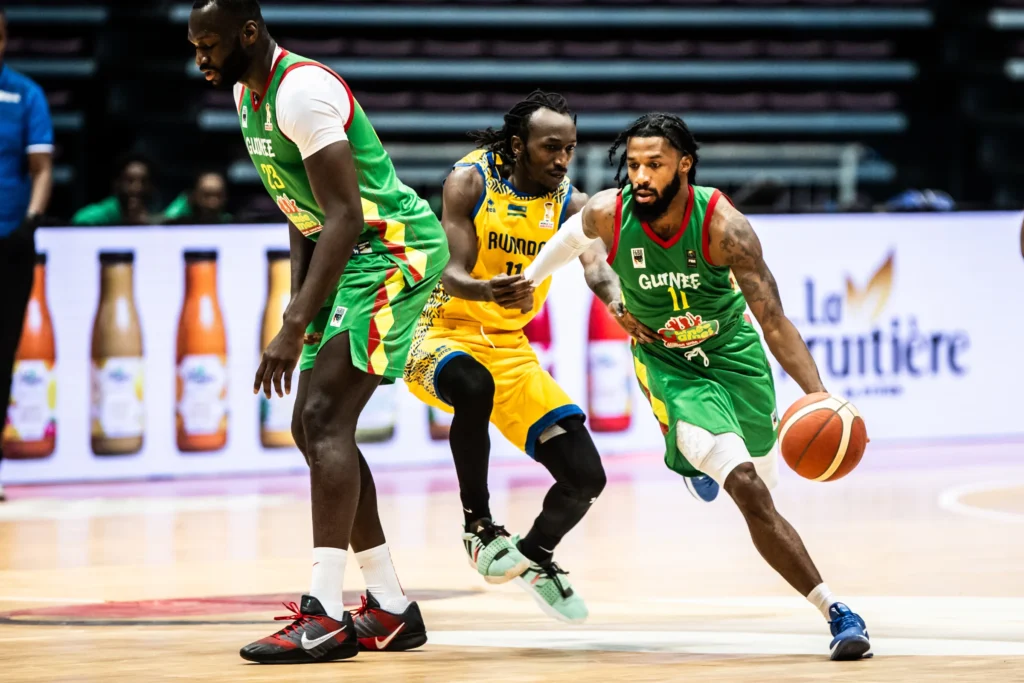 Guinea's Shannon Evans in action against Rwanda