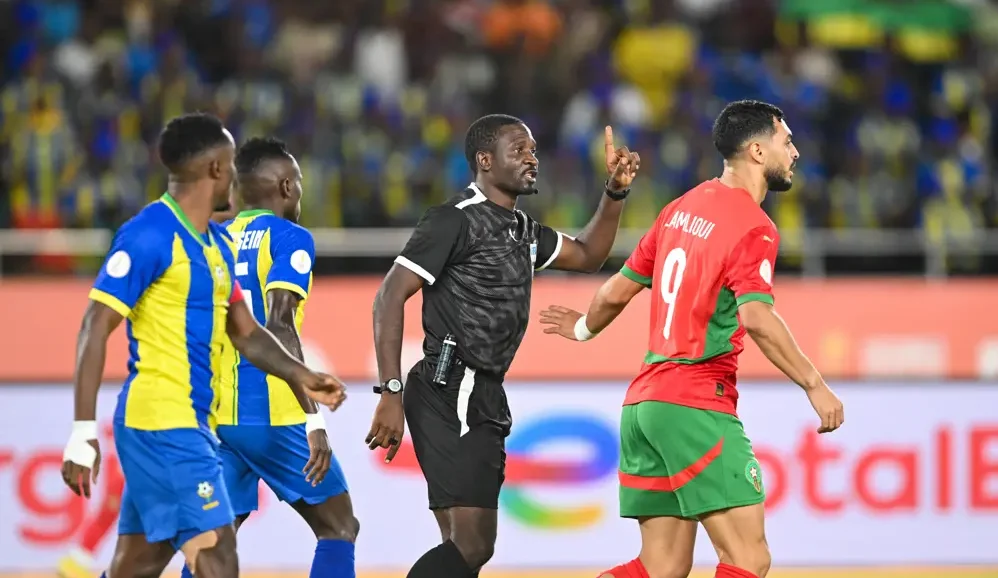 Referee Abdou Abdel Mefire (middle)