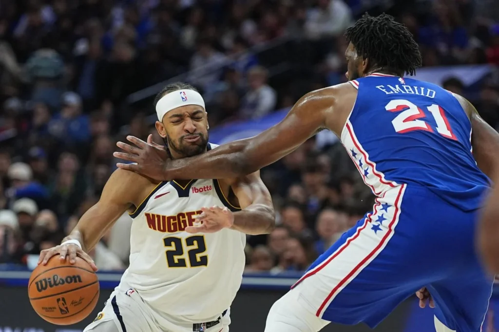 Zeke Nnaji (left) guarded by Philadelphia 76ers' Joel Embiid