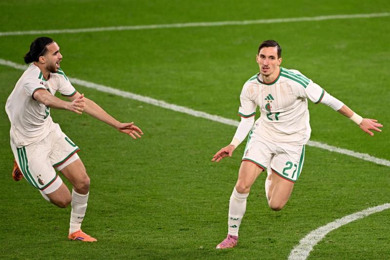Ramiz Zerrouki (left) celebrating a goal for Algeria