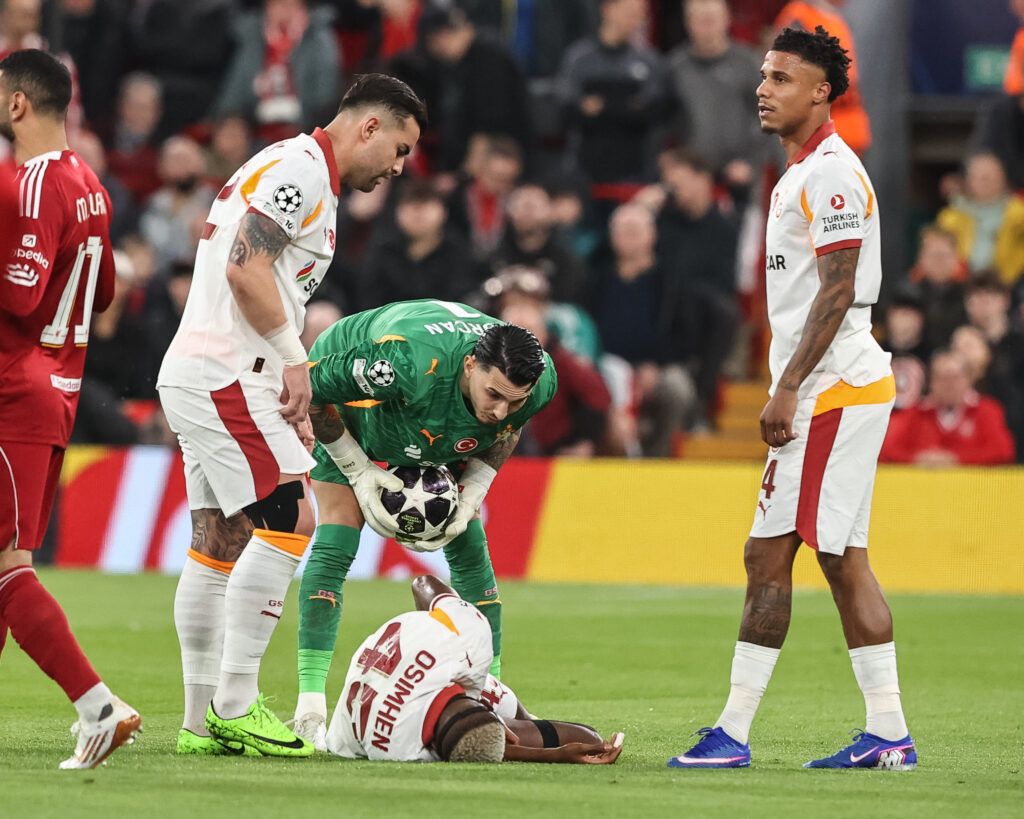 Osimhen receiving attention from teammates after his injury