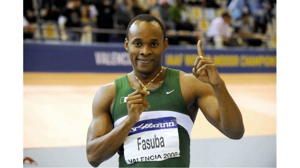 Olusoji Fasuba reacts after Kanyinsola Ajayi broke the Nigerian 100m record