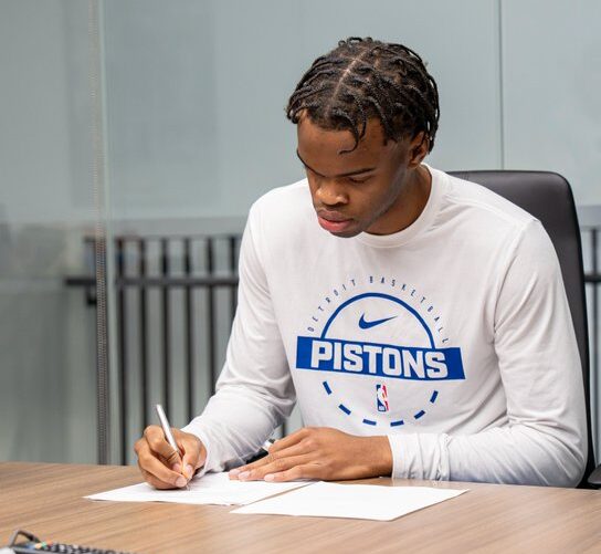 Ebuka Okorie signing the dotted lines