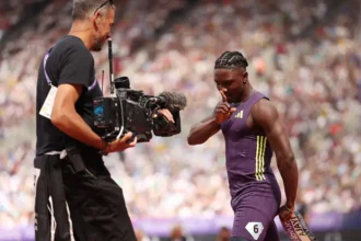 Kanyinsola Ajayi celebrates winning the 100m sprint at the London Diamond League